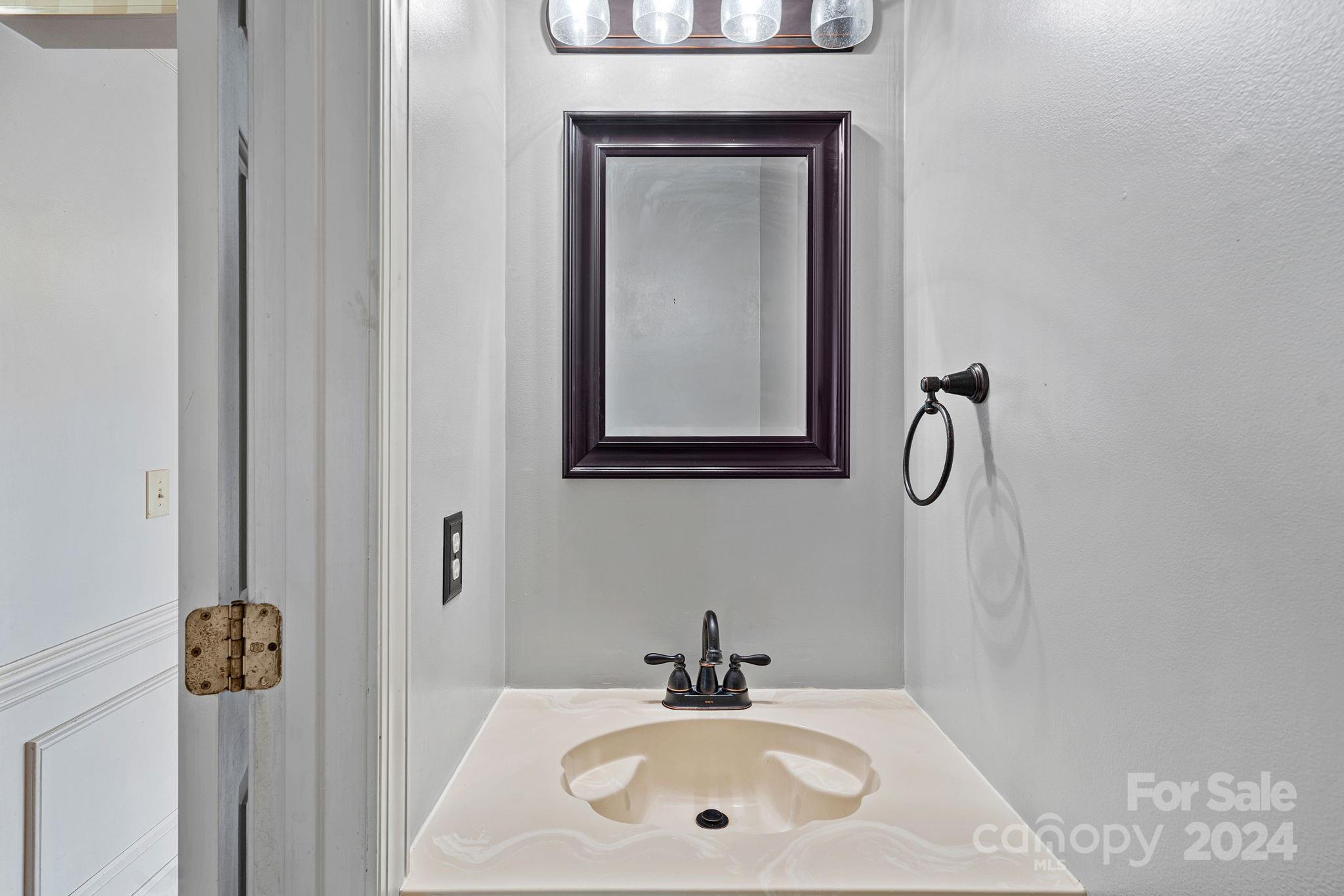 12516 Hawks Ridge Road Huntersville, NC 28078 - Photo 12 of 36 a bathroom with a sink and mirror