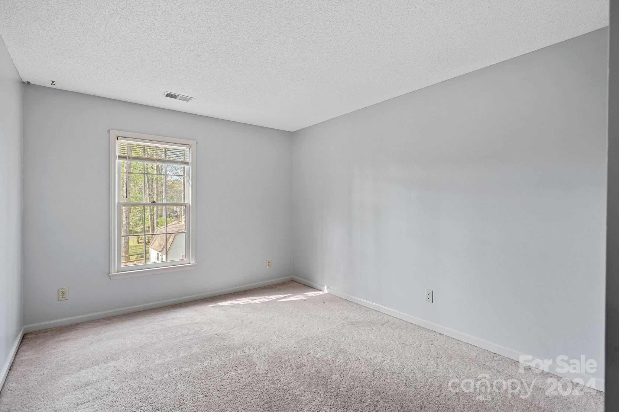 12516 Hawks Ridge Road Huntersville, NC 28078 - Photo 15 of 36 an empty room with a window