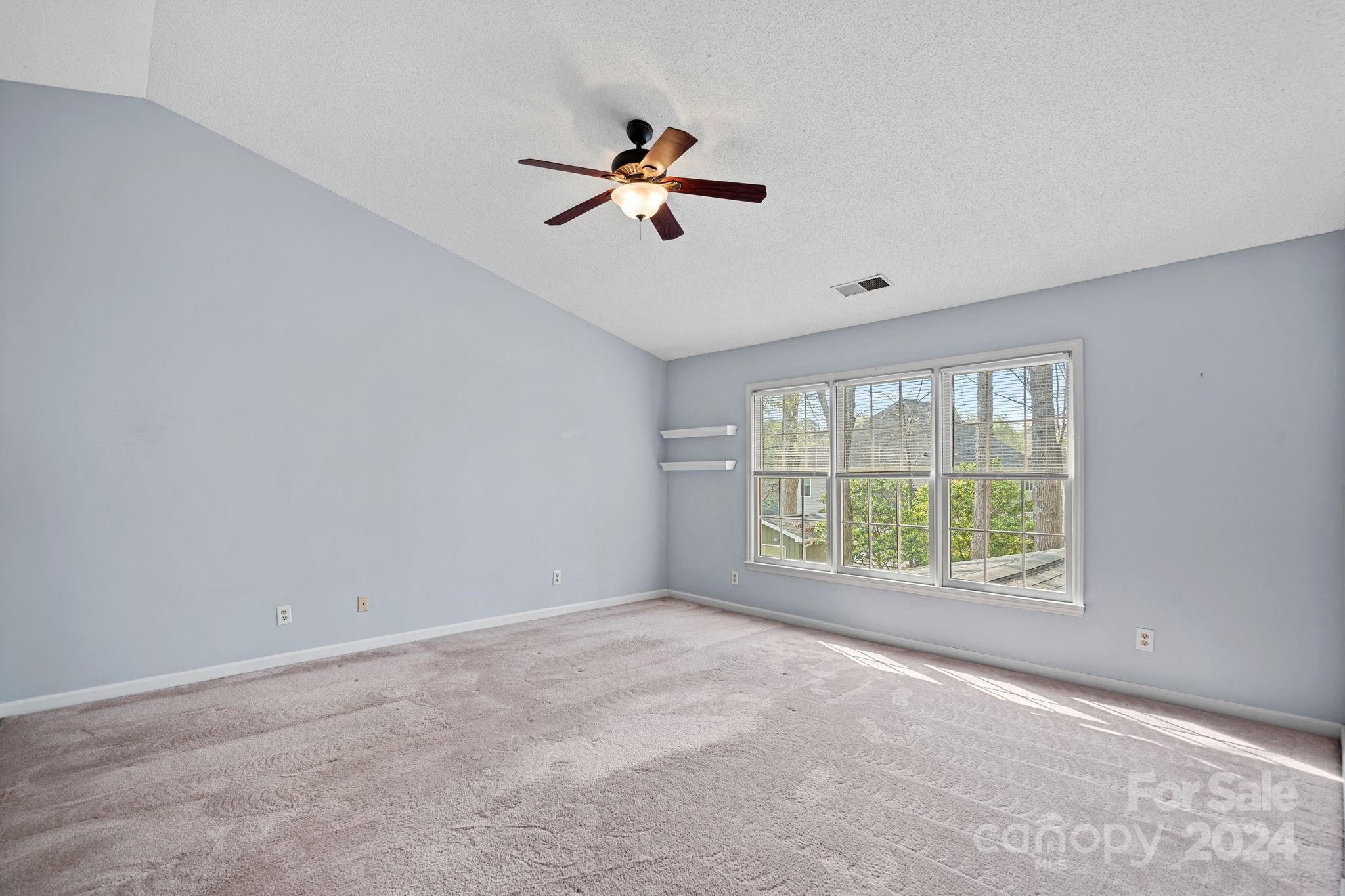 12516 Hawks Ridge Road Huntersville, NC 28078 - Photo 18 of 36 a view of a livingroom with a ceiling fan and window