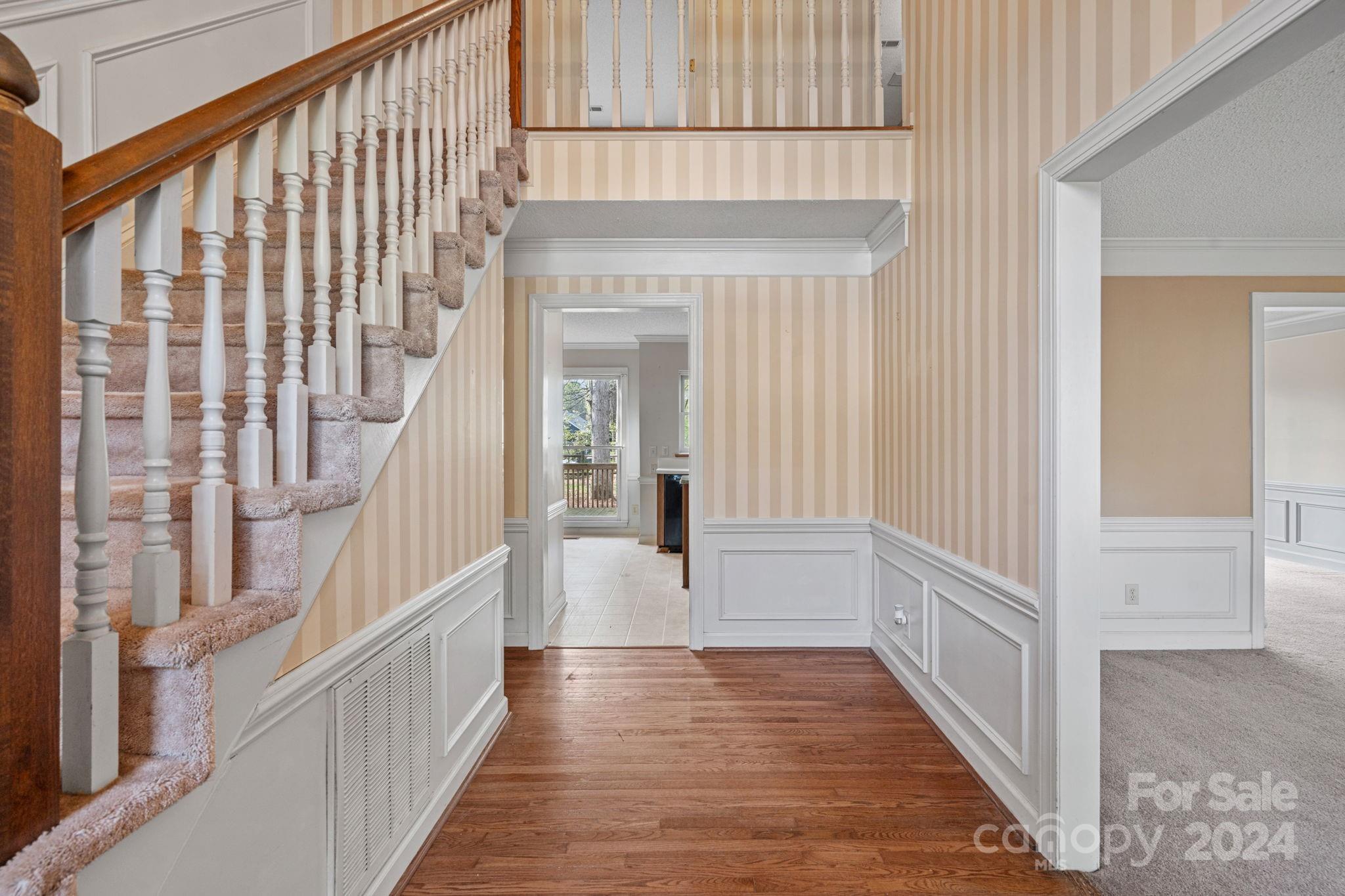 12516 Hawks Ridge Road Huntersville, NC 28078 - Photo 2 of 36 a view of a hallway with wooden floor and staircase