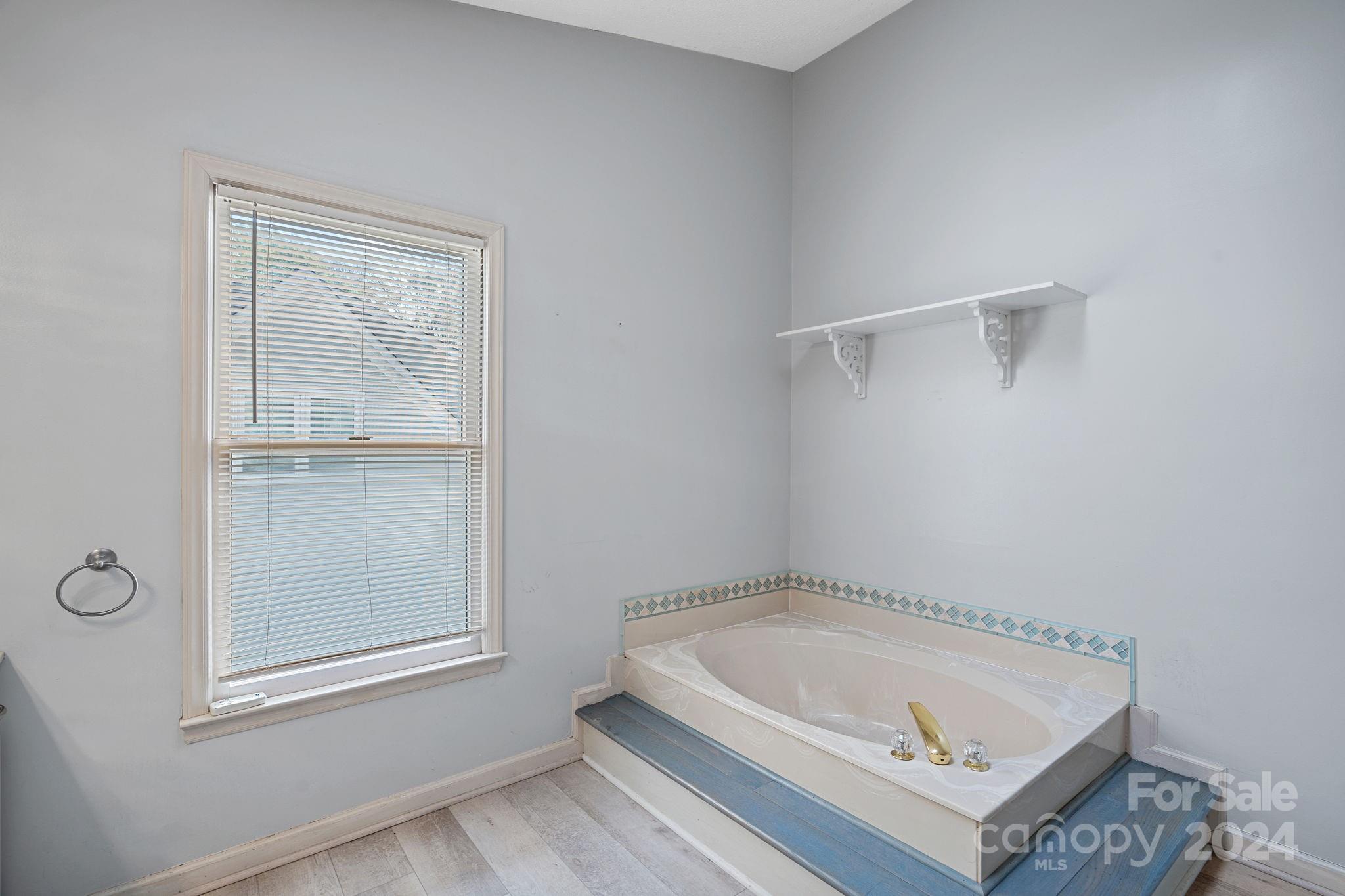 12516 Hawks Ridge Road Huntersville, NC 28078 - Photo 21 of 36 a bathroom with a tub and shower