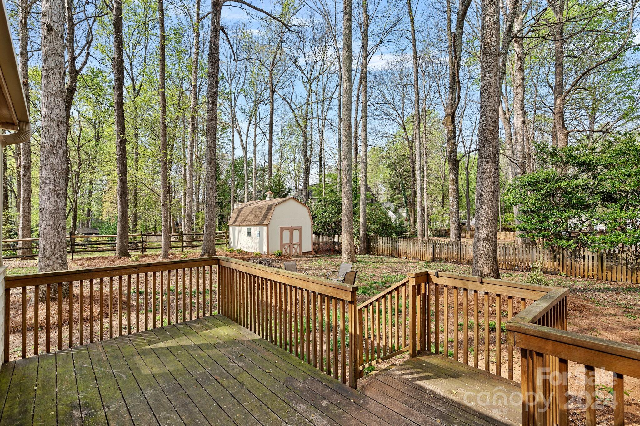 12516 Hawks Ridge Road Huntersville, NC 28078 - Photo 27 of 36 a view of a wooden deck with large trees