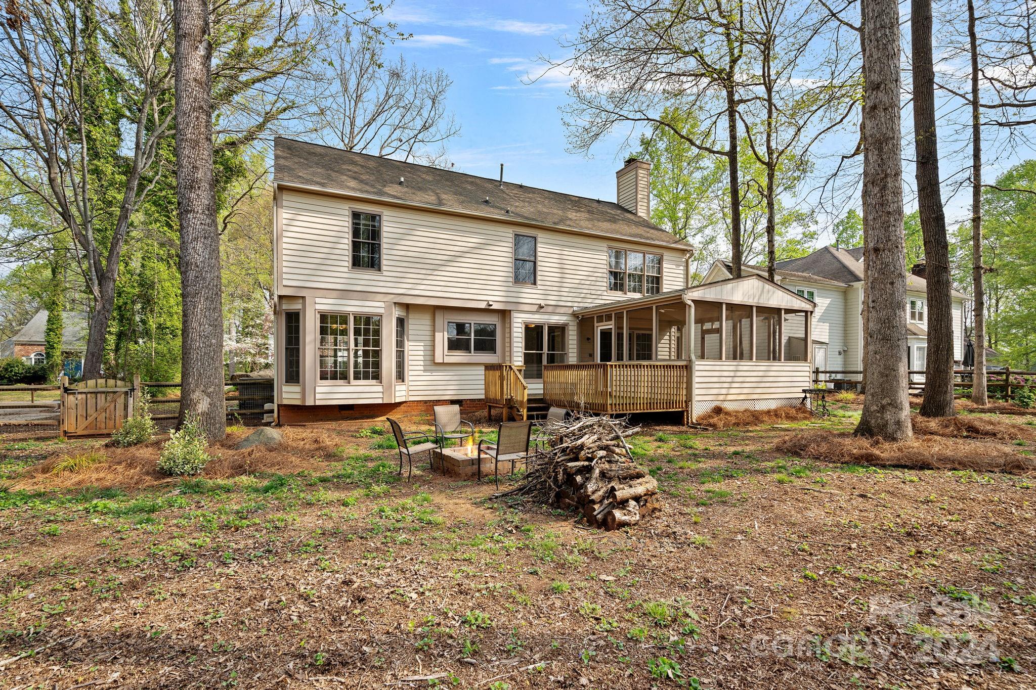 12516 Hawks Ridge Road Huntersville, NC 28078 - Photo 29 of 36 a view of a house with a yard chairs and floor to ceiling window