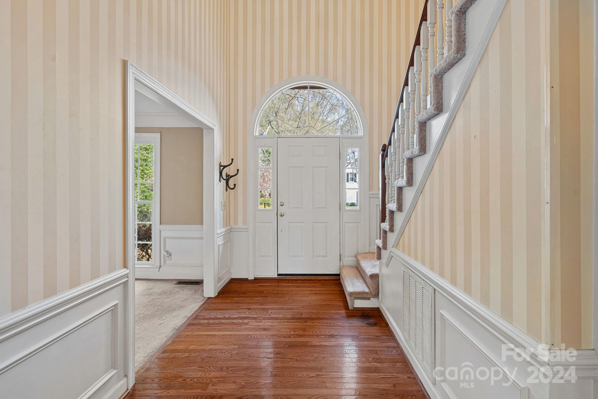12516 Hawks Ridge Road Huntersville, NC 28078 - Photo 3 of 36 a view of a hallway with wooden floor and staircase