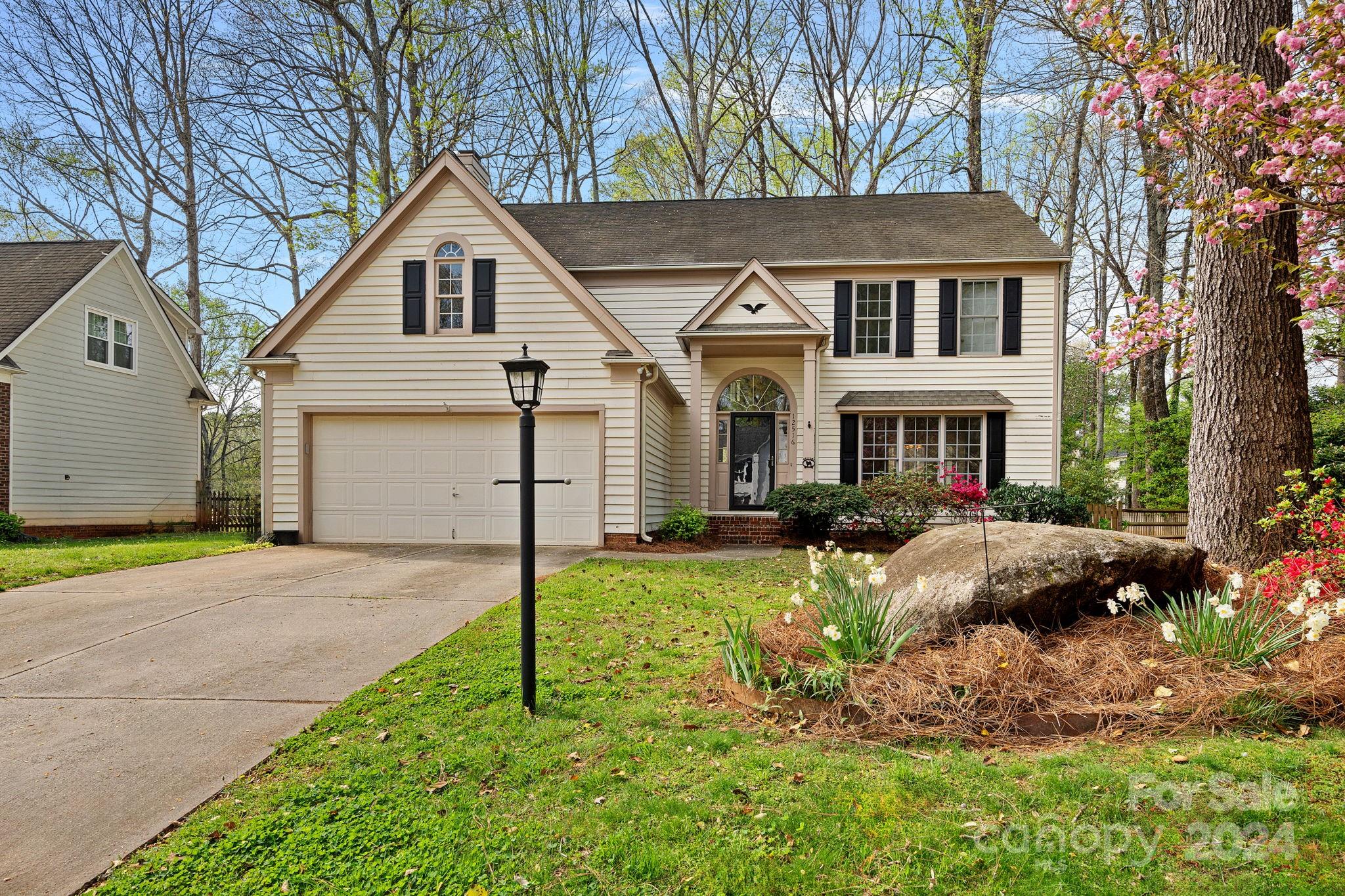 12516 Hawks Ridge Road Huntersville, NC 28078 - Photo 33 of 36 a front view of a house with a yard and garage