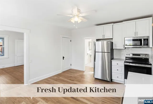 a kitchen with a refrigerator a stove top oven a refrigerator and a sink