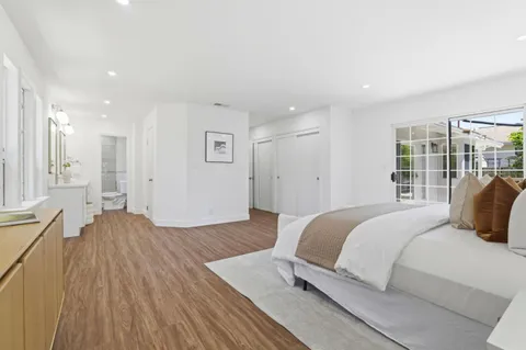 a spacious bedroom with a bed and a window