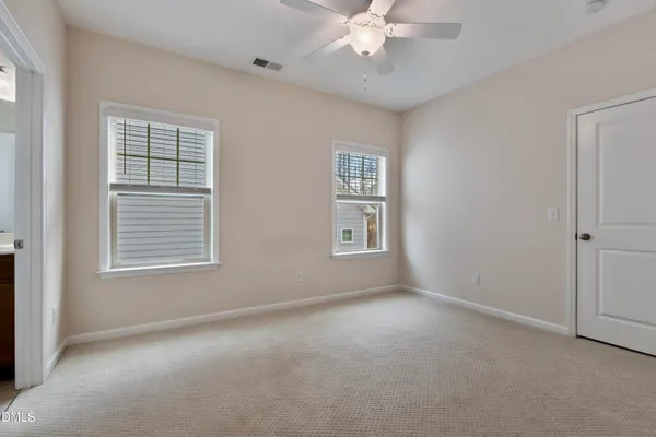 a living room with furniture and a ceiling fan