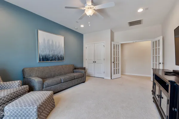 a bedroom with a bed and a chair