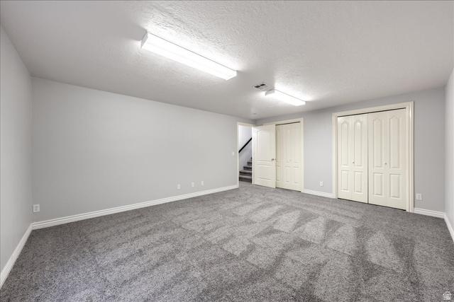 7 Reflection Way St. George, UT 84770 - Photo 30 of 54 Finished basement featuring a textured ceiling, stairway, and carpet flooring
