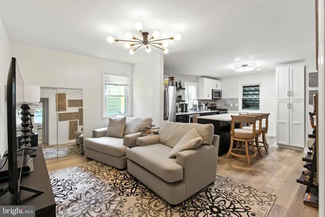 a living room with furniture and kitchen view