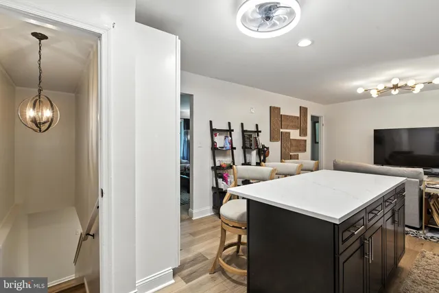 a room with a table chairs and a refrigerator