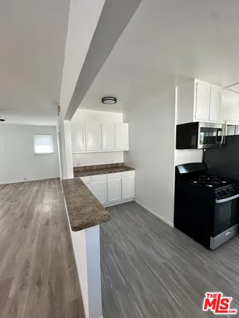 a living room with hard wood floors and furniture