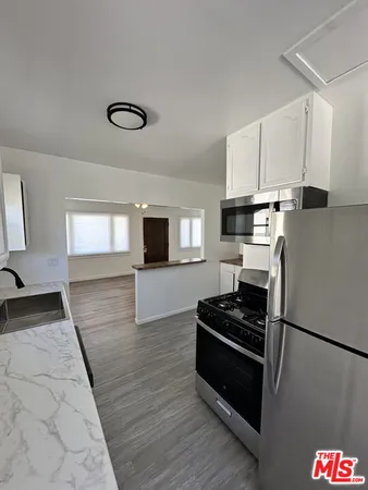 a kitchen with stainless steel appliances a refrigerator stove and microwave
