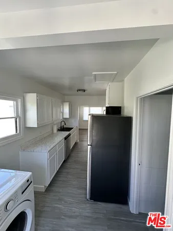 a kitchen with a refrigerator and a stove