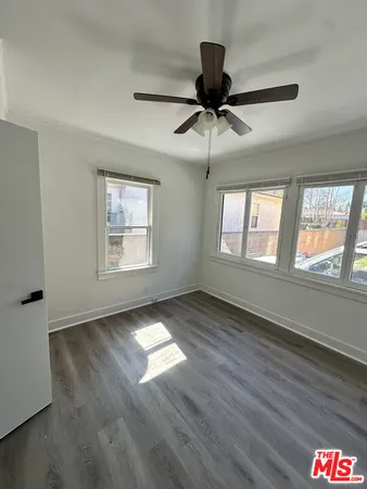 a view of an empty room window and wooden floor