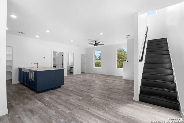 a view of a kitchen with wooden floor and stairs