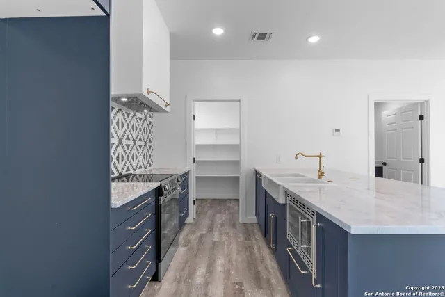 a kitchen with a sink and cabinets