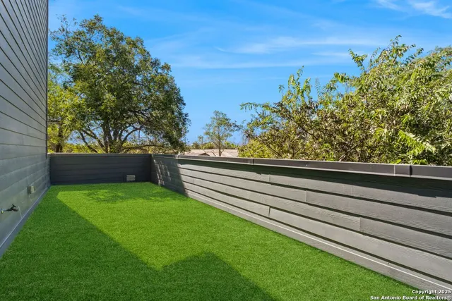 a view of a back yard from a balcony