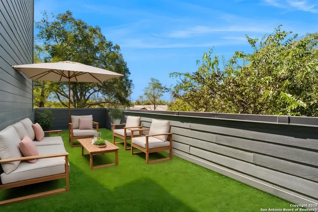 a view of a chairs and table in patio