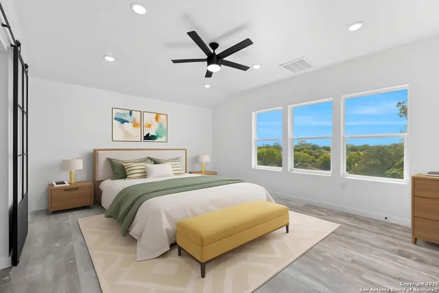 a bedroom with a large bed and a large window