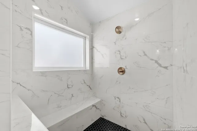 a bathroom with a bathtub and a shower