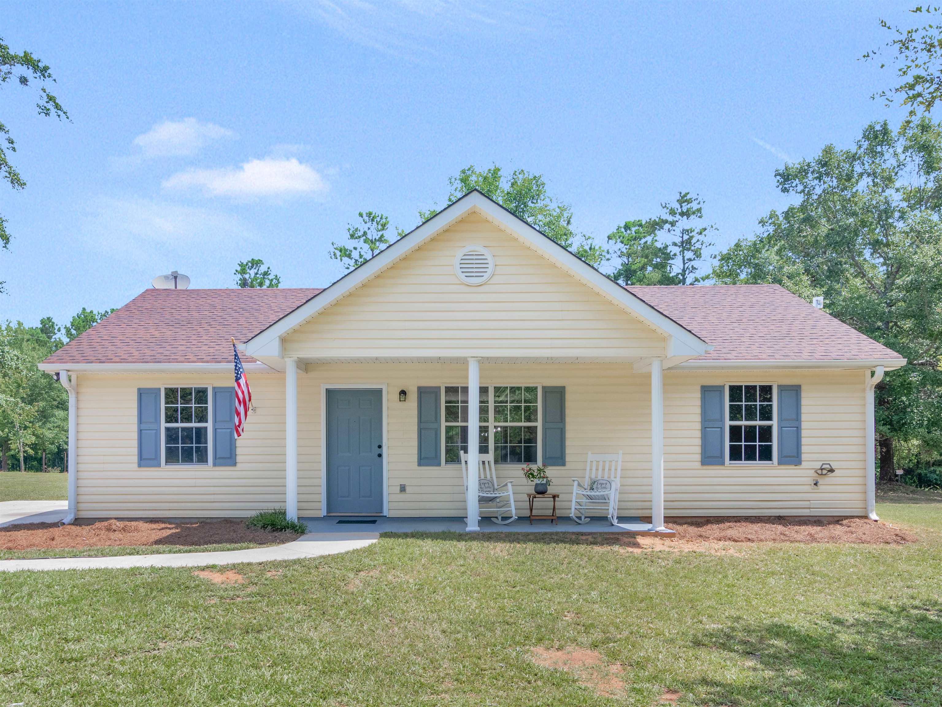 1294 Chappell Mill Road Jackson, GA 30233 - Photo 1 of 1 a front view of a house with a yard and garage
