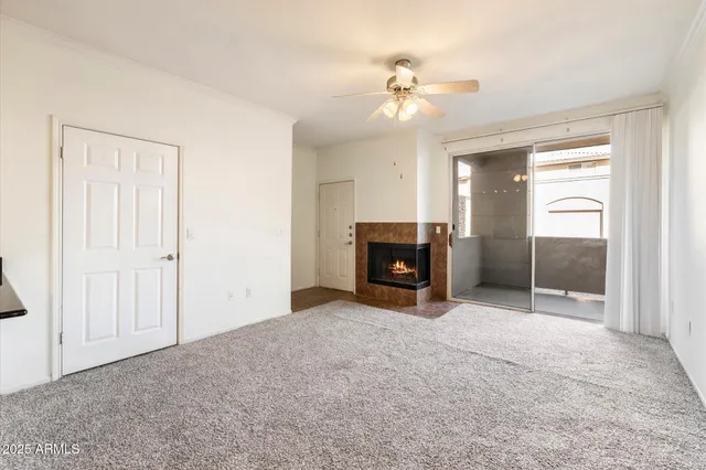 a view of empty room with a fireplace