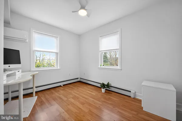 a view of a livingroom with wooden floor and a window