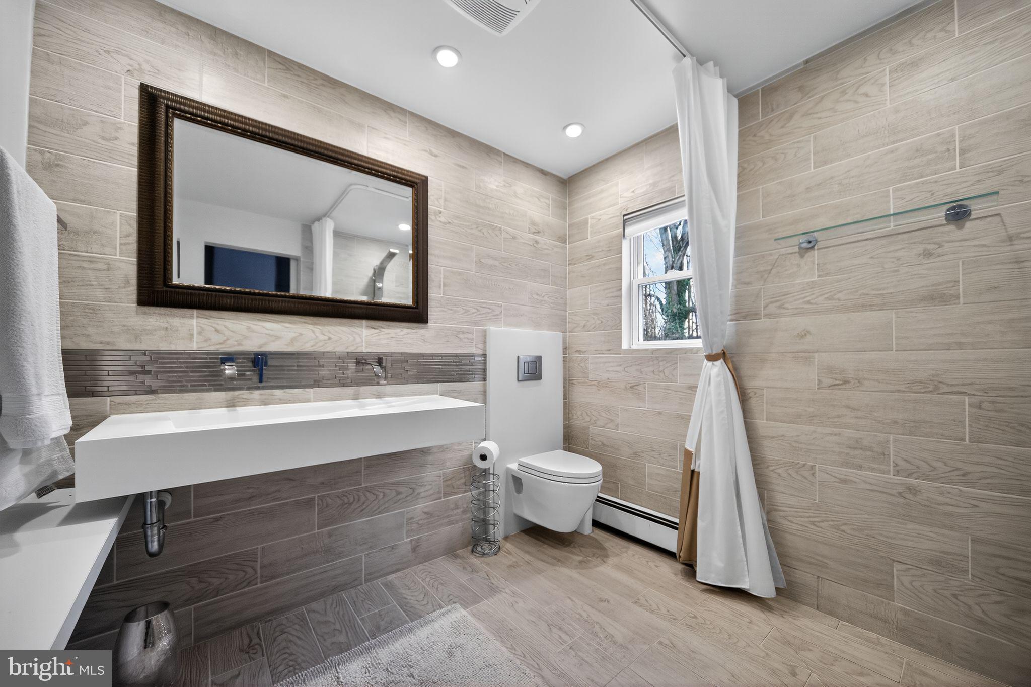 575 West Valley Road Wayne, PA 19087 - Photo 17 of 36 a bathroom with a sink and a mirror