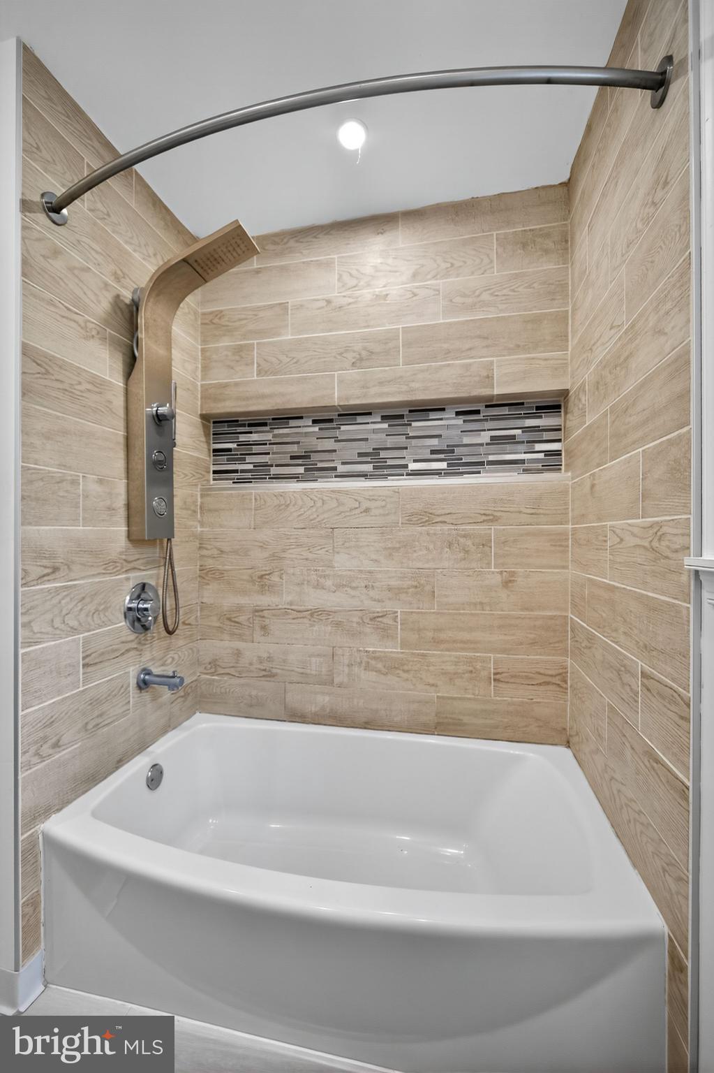 575 West Valley Road Wayne, PA 19087 - Photo 25 of 36 a bathroom with a bathtub and shower