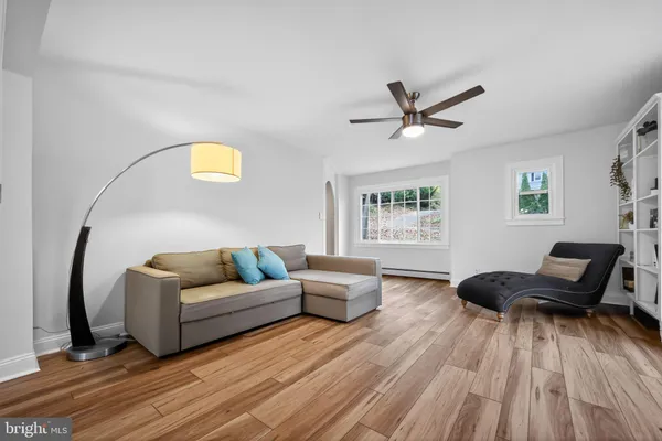 a kitchen with stainless steel appliances granite countertop a white cabinets a sink dishwasher and a stove with wooden floor