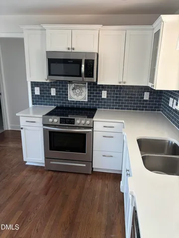 a kitchen with a stove and a microwave