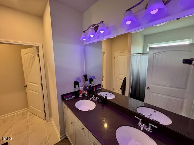 140 Continental Lane Smithfield, NC 27577 - Photo 16 of 28 a bathroom with a granite countertop sink a mirror and shower