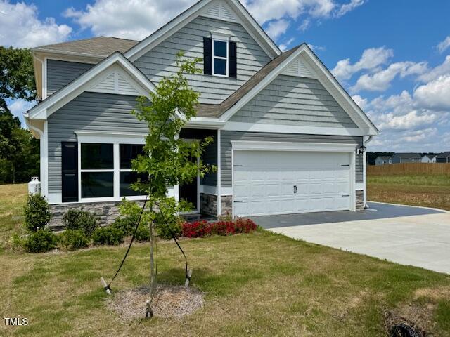 140 Continental Lane Smithfield, NC 27577 - Photo 2 of 28 a house view with a garden space