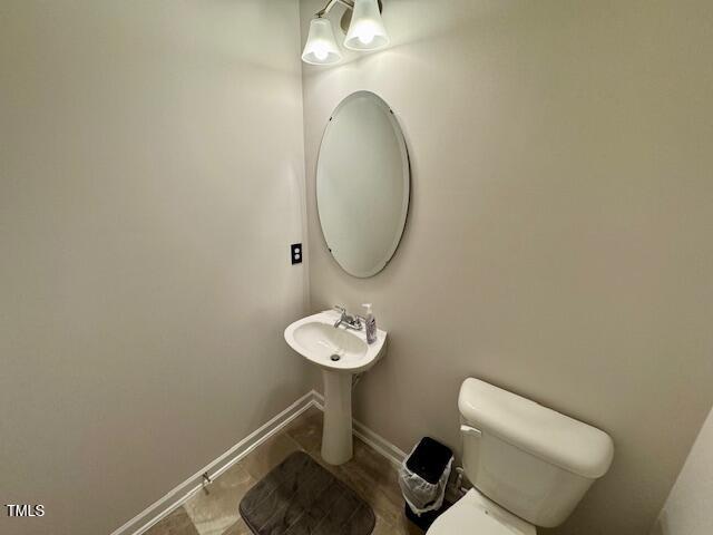 140 Continental Lane Smithfield, NC 27577 - Photo 10 of 28 a bathroom with a toilet and a sink
