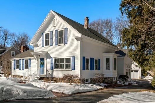 103 Oak Street Reading, MA 01867 - Photo 1 of 35 a view of a white house with large windows next to a road