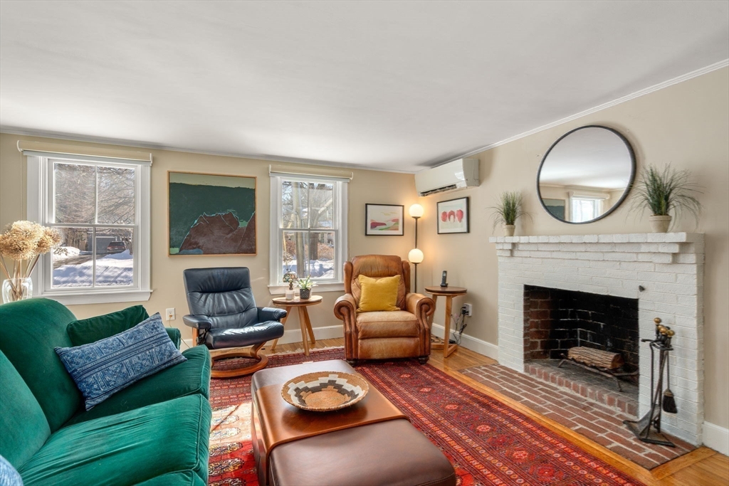103 Oak Street Reading, MA 01867 - Photo 16 of 35 a living room with furniture a rug a fireplace and a large window