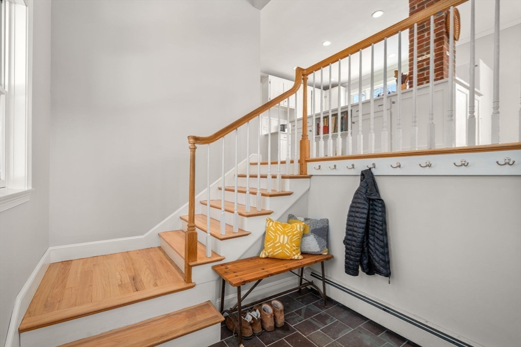 103 Oak Street Reading, MA 01867 - Photo 23 of 35 a view of a hallway with chairs and a potted plant