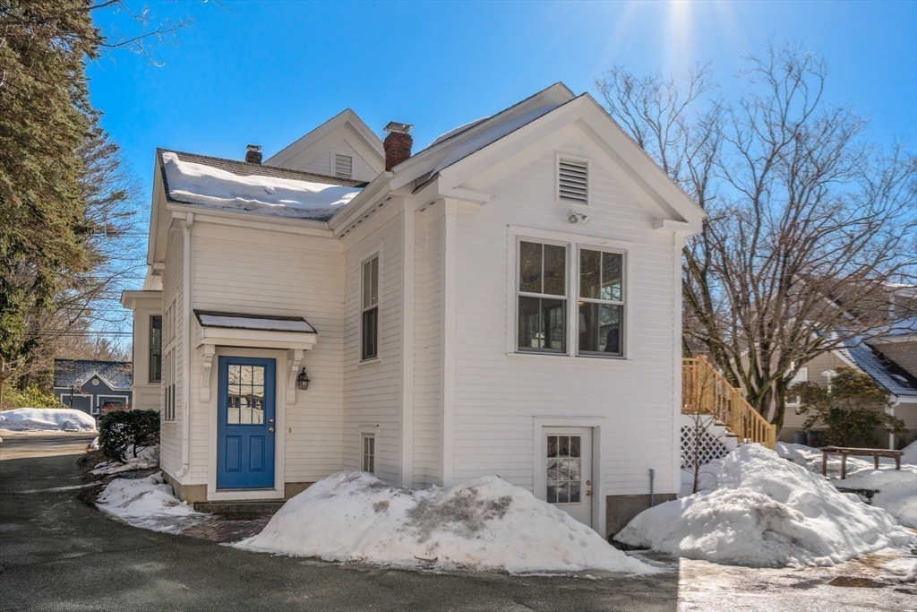 103 Oak Street Reading, MA 01867 - Photo 29 of 35 a front view of a house with a yard