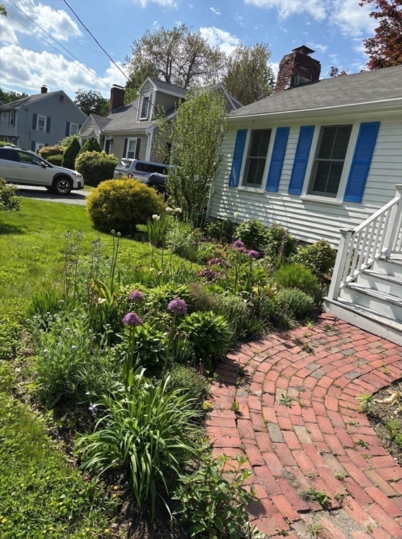 103 Oak Street Reading, MA 01867 - Photo 30 of 35 a front view of a house with a yard
