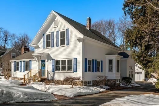 103 Oak Street Reading, MA 01867 - Photo 34 of 35 a view of a white house with large windows next to a road