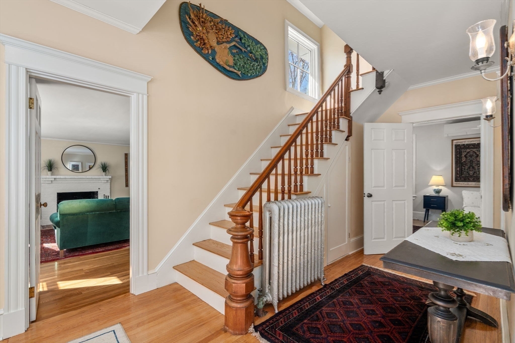 103 Oak Street Reading, MA 01867 - Photo 5 of 35 a view of a hallway with entryway wooden floor and front door