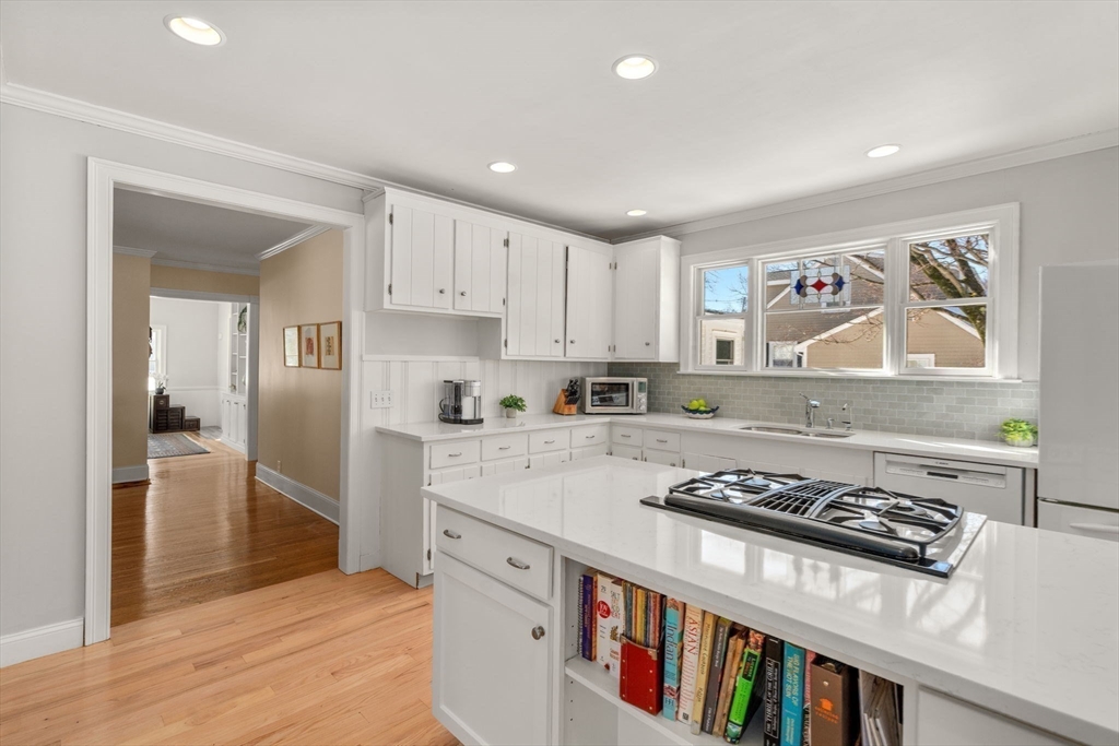 103 Oak Street Reading, MA 01867 - Photo 8 of 35 a kitchen with stainless steel appliances granite countertop a stove and a refrigerator