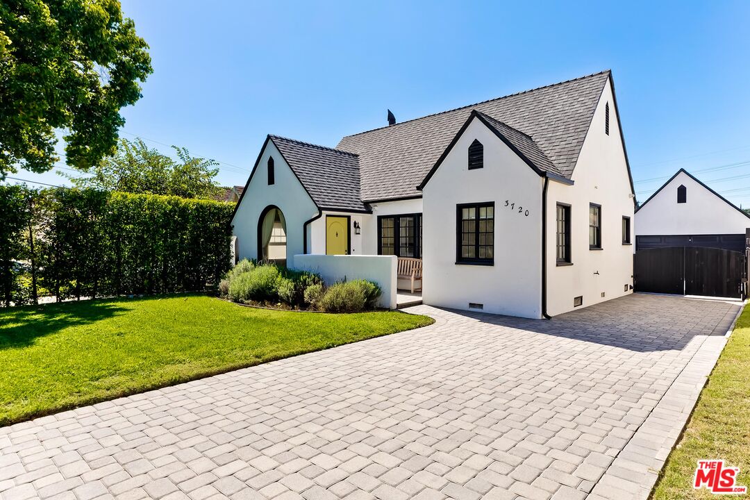 3720 Valleybrink Road Los Angeles, CA 90039 - Photo 1 of 31 a front view of a house with a yard and garage