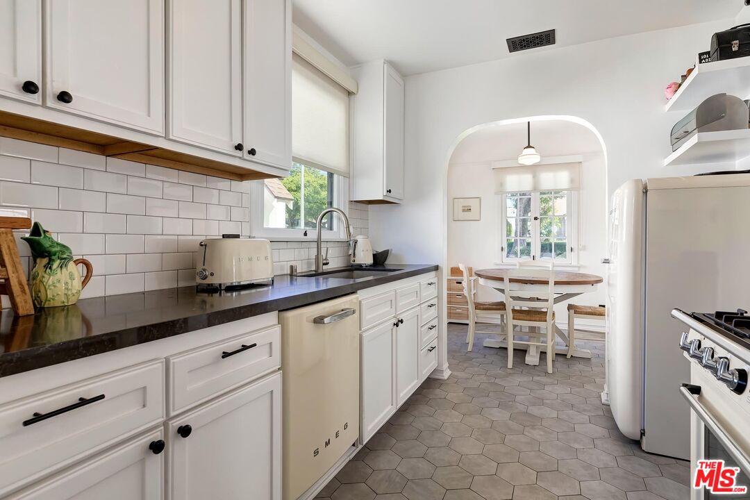 3720 Valleybrink Road Los Angeles, CA 90039 - Photo 14 of 31 a kitchen with sink cabinets and window