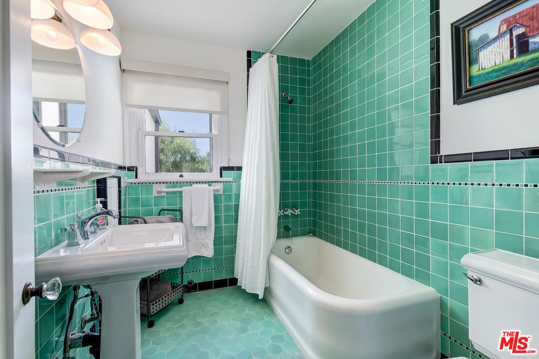 3720 Valleybrink Road Los Angeles, CA 90039 - Photo 23 of 31 a bathroom with a sink a toilet a mirror and bathtub