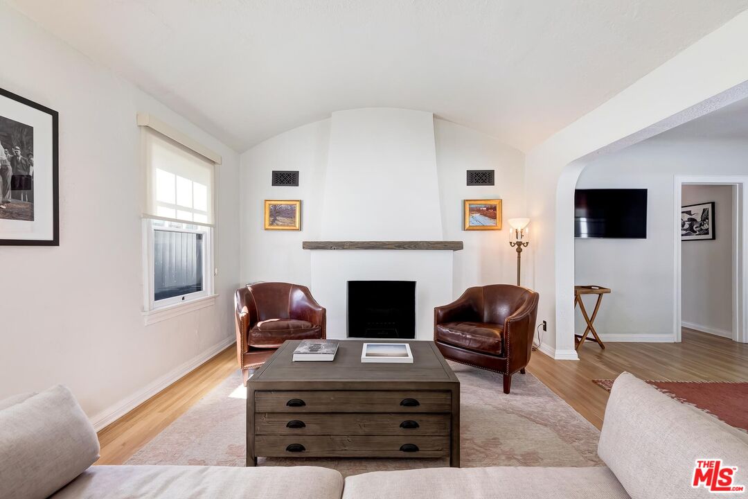 3720 Valleybrink Road Los Angeles, CA 90039 - Photo 4 of 31 a living room with furniture and a fireplace