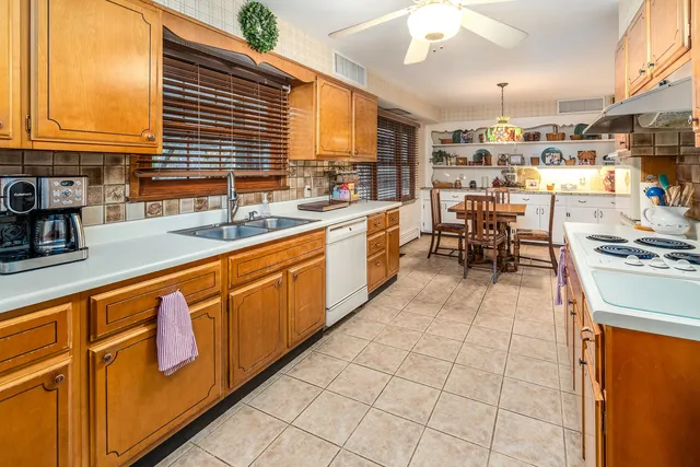 a kitchen with stainless steel appliances granite countertop a sink and cabinets