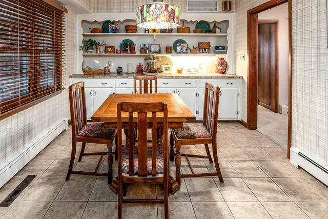 a dining table chair in a kitchen and a window